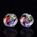 Macro detail of silver floral stud earrings featuring colorful zircons and clear crystals - Purple Red Green