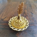 Golden Middle Eastern incense burner with an elegant feather lid and hollowed engraving - Feather