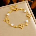 Detail of gold double-layer chain bracelet with white pearls and zircon flower charms - Double Layer Pearl And Zircon Four Leaf Flower Style (B1501)