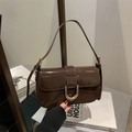 Dark brown patent leather baguette bag with a gold horse-shoe buckle and shoulder strap - Brown