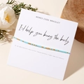 Detail of Morse code beaded bracelet with gift card 'I'd help you bury the body' on wood - Blue Gold Style (GZ-B24061120A-P)