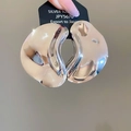 Macro shot of silver 925 irregular wavy earrings with a high-polished mirror finish - Silver