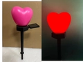 Pink heart solar garden stake light showing daytime view and red glowing effect - Single Heart Peach Pink