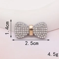 Detail shot of a rhinestone bow accessory measuring 2.5cm by 1.4cm for DIY crafts - D350 White Rhinestone Bowknot