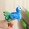 Cute bright blue peacock plush finger puppet with green eye-pattern tail fan on finger - Peacock
