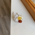 Detail of beaded ring with white mother-of-pearl and amber resin beads on a desk - Style H Irregular Yellow Acetate Colorful