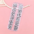 12-grid box of silver nail art rhinestones in various shapes on a pink background - 12 Colors Silver Shaped Rhinestones