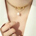 Golden mesh necklace with letter M pendant and freshwater pearl on female model - Gold Color Freshwater Pearl Necklace / 32+5cm