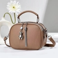 Brown PU leather crossbody bag with tassel and bear pendant in studio setting - Khaki
