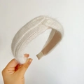 Close-up of a white plush knit headband featuring a stylish central knot design - Cross Knot / Beige