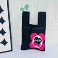 Black knit tote bag with pink flower and ACML CLOVND lettering for casual use - HAPPY Black