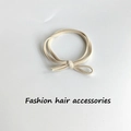 Beige high-elasticity braided hair tie with a minimalist knotted bow design on white back - 1 Piece / Beige
