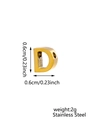 Macro detail of a 0.6cm golden stainless steel letter D pendant with size markings - Letter-D / Gold