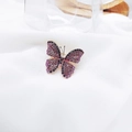 Exquisite butterfly brooch with purple and black rhinestones on soft white fabric - Purple