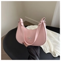 Detailed shot of pink crescent moon bag featuring silver bow accent and adjustable strap - Pink