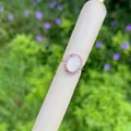 Detailed macro view of an oval vintage gold ring with purple zircons and Mary relief - Purple