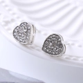 Macro shot of silver heart earrings with cubic zirconia on a white embossed tray - D17 Silver Heart