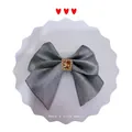 Grey satin bow hair accessory featuring a central amber gemstone with rhinestone trim - Smoke