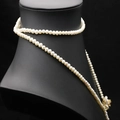 Elegant natural white pearl necklace with gold flower clasp on black neck display stand - Gold Flower Clasp Style