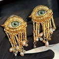 Golden Evil Eye tassel earrings with green eye charm and pink baroque pearl drop - Clip-on Earrings