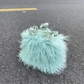 Close-up of mint green faux sheepskin bucket bag with drawstring and long fuzzy texture - Mint Green