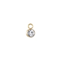 Close-up of a round gold pendant with a faceted zircon stone and minimalist metal base - White