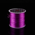 Purple elastic crystal string for DIY jewelry making on a sleek reflective black surface - Reddish Purple