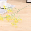 Detailed close-up of yellow artificial baby's breath flowers on light wood surface - Diamond-Yellow