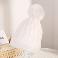 Classic white cable knit beanie for women featuring a fluffy faux fur pompom decoration - White