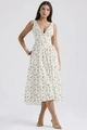 Detailed close-up of a white floral V-neck midi dress with delicate green flower prints - White Green Leaf