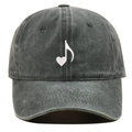 Close-up of heart and music note embroidery on a dark grey washed cotton baseball cap - Green