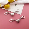Silver heart-shaped magnetic necklace connectors with lobster clasps on pink background - White K Heart-Shaped Magnetic Clasp / 9x39mm