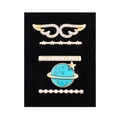 Detail view of five gold charms with wings, stars, and pearls for silicone watch bands - Wings and Planet Design (D3011) / Black Sponge Packaging
