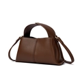 Detail of brown litchi pattern leather handbag showing handle and shoulder strap - Coffee