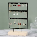 Three-tier black metal earring display stand with wooden base on marble surface - Small 3-Tier 36 Holes Black