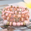 Böhmisches mehrlagiges Perlenarmband-Set mit rosa Kristallen und Schmetterlingsanhänger - Warmer Ton