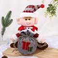 Cute Christmas elf doll in red knit outfit holding a grey burlap apple gift bag - Burlap Sitting Drawstring Elf