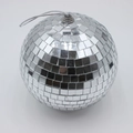 Close-up of silver disco mirror ball with reflective glass tiles on white background - 15cm With Cap