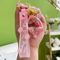 Porte-clés fraise liquide rose avec paillettes flottantes et dragonne Lucky rose - Forme de fusée avec bracelet en silicone