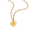 Gold heart pendant necklace with blue zircon starburst inlay on a gold metal chain - September/Sapphire