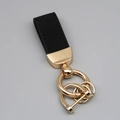 Suede leather keychain with black strap and golden hardware in a professional studio setting - Short Style / Black/Gold