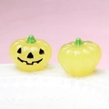 Detailed view of yellow luminous Halloween pumpkins with spooky face on white plate - Luminous Light Yellow (Black Expression)