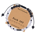 Detail of Morse code bracelet with black lava and white stones on themed display card - Fuck Off