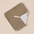 Detail of olive green cotton muslin baby bib with pom-pom trim and white snap buttons - Dark Khaki And White