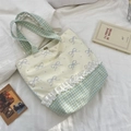 Detailed close-up of canvas tote bag featuring floral lace trim and blue checkered base - Cream Base Handheld Style (Purple Bowknot)