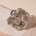 Detail of silver floral cuff bracelet with irregular hammered texture on natural stone - Silver