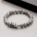 Detail view of 8mm marble textured stone beads and a carved metal skull charm bracelet - Picasso Stone (KB183252-TLX)