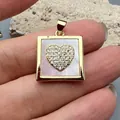 Detailed macro view of square gold-plated pendant with purple mother of pearl and zircon heart - Heart