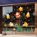 Cartoon Christmas window stickers featuring Santa, snowman, and reindeer on glass display - Christmas Stars 6112