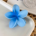 Detail of blue gradient frangipani flower hair claw clip with a matte finish texture - Blue Flower